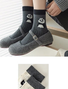 Detail of grey crew socks with cute panda embroidery and vertical ribbed knit texture