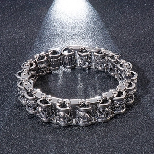 Macro detail of men's stainless steel dragon chain bracelet with retro mechanical links