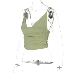 Detail of green V-neck camisole featuring ruched texture and slim fit style