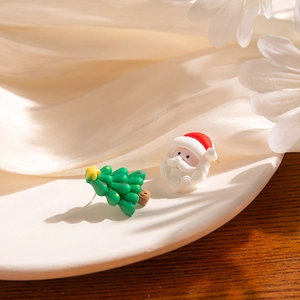 Asymmetric Christmas Santa Claus and tree stud earrings on elegant white silk background