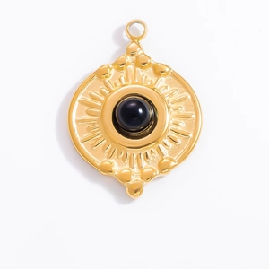 Macro detail of French vintage 18k gold pendant with obsidian and sunburst texture