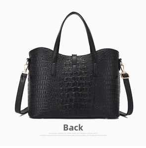 Back view of a black crocodile-embossed tote bag featuring dual handles and metal buckles