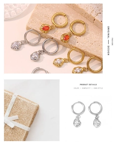 Detailed view of fashionable hoop earrings with irregular zircon stones in gold and silver