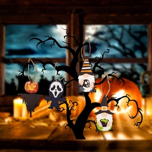 Detailed view of Halloween wooden ghost and pumpkin ornaments hanging on a dark branch tree