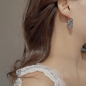Irregular lava texture S925 sterling silver earrings worn by a model in minimalist style