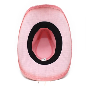 Detail of pink paper fiber cowboy hat interior with black sweatband and 100% paper tag