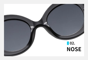 Detail view of smooth black nose bridge design on retro oval frame sunglasses