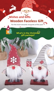 Detail of two Nordic wooden Christmas gnomes with faux fur beards and snowflake patterns