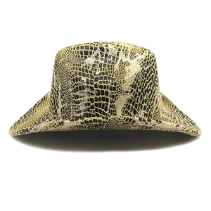Detailed macro view of metallic gold snakeskin texture on a western cowboy hat surface