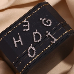 Silver twisted rope letter charms C H D J and numbers on luxury silk background