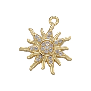 Macro detail of sun-shaped gold charm with micro-paved cubic zirconia stones and top loop