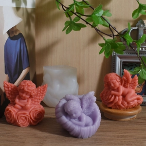 Sleeping angel and rose wing silicone candle molds in coral pink and lilac purple