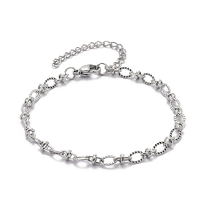 Macro detail of textured circular links and lobster clasp on silver paperclip chain bracelet