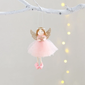 Pink Christmas angel ornament with golden wings hanging on a white branch decorations