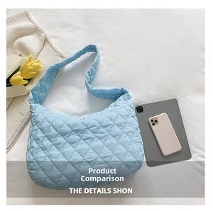Detailed close-up of sky blue quilted cloud shoulder bag with spacious interior and soft fabric