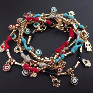 Handmade woven Evil Eye and Hamsa Hand friendship bracelets in multiple colors