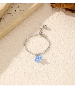 Detailed macro view of S925 sterling silver chain ring with a blue star crystal pendant