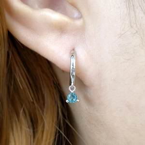 Close-up of sky blue zircon drop earrings in 925 silver with polished round hoops