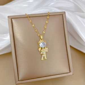 Close-up of gold necklace featuring a reading girl pendant with sparkling pavé zircons