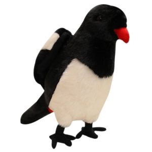 Realistic black and white puffin bird plush toy with red beak standing on white background