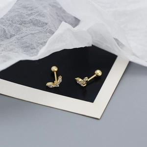 Macro detail of gold-toned 925 silver stud earrings with sparkling marquise zircons
