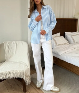 Detail of blue and white striped long sleeve shirt with relaxed cotton fit for women