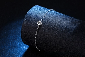 Macro shot of s925 silver bezel-set moissanite stone on a delicate minimalist chain