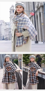 Detail of plaid scarf with large floral pattern and fringes in blue and black colors