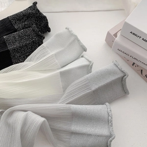 Detail of sheer ballet-style crew socks with glitter trim and ribbed texture in three colors