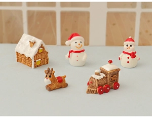 Detailed view of 5-piece Christmas miniature set with gingerbread house and snowmen