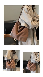 Detail of vintage brown suede tote bag featuring leather patchwork and adjustable strap