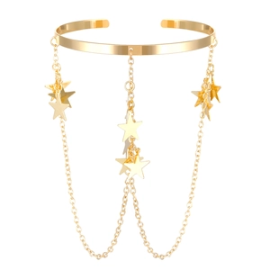 Close-up of gold chain fringe with star charms on a metal arm cuff or choker