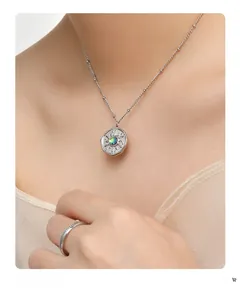 Detail shot of silver necklace and ring set with sunburst pendant and green gemstone