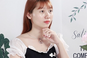Close-up of minimalist stainless steel coin pendant necklace on model neck