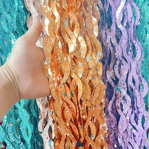 Star cutout orange tinsel curtain with metallic sheen for festive party backdrop decorations