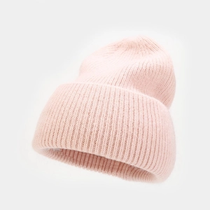 Detailed texture of thick vertical striped knit on a soft light pink rabbit hair warm hat