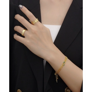 Elegant s925 silver gold bracelet and rings set with green gem and textured metal finish
