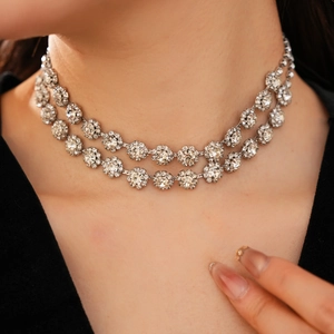 Close-up of sparkling double-layer rhinestone flower necklace worn by a model