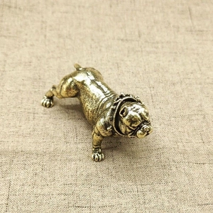 Detailed view of a vintage bronze bulldog statue with realistic muscle lines and spikes