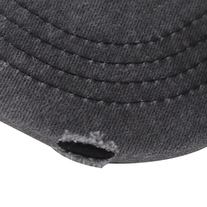 Close-up of distressed charcoal cotton fabric with vintage worn details on baseball cap