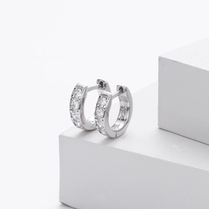 Minimalist S925 sterling silver hoop earrings with white zircon stones on white display
