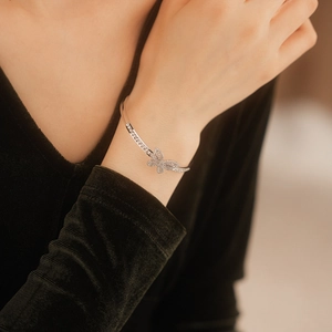 Detailed view of a silver butterfly cuff bracelet featuring shimmering pavé cubic zirconia