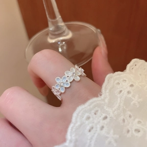 Close-up of elegant flower ring with white petals and crystals on model hand