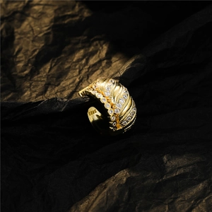 Sparkling gold-plated S925 silver wave ring with pavé zircons on black background
