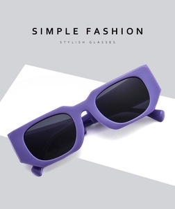 Detail of purple rectangular sunglasses with thick frames and dark lenses in minimalist style