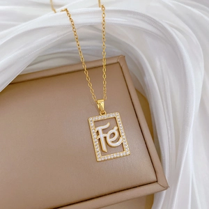 Macro view of gold titanium necklace with hollow square pendant and sparkling crystals