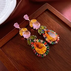 Luxurious drop earrings with multi-color zircon stones and gold leaf design on wood