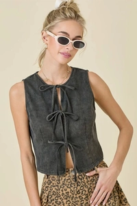 Detail of dark grey washed denim vest with triple bow tie-up front closure for women