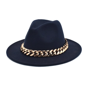 Detailed view of dark navy wool fedora hat featuring a chunky gold chain strap decoration