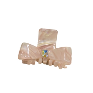 Pink marble acetate bow hair claw clip with a sparkling rhinestone center for women